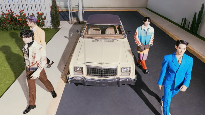 SHINee members in a retro setting with a car
