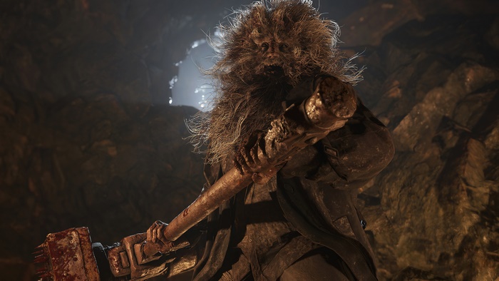 Resident Evil Village character with hammer in cave