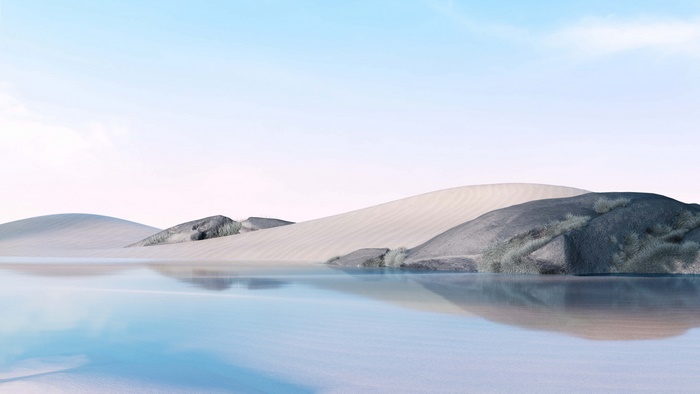 Desert landscape with sand dunes and a calm body of water