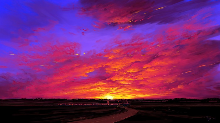 Train passing by during a vibrant sunset with dramatic clouds