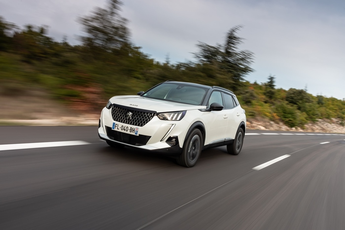 White Peugeot 2008 GT Line SUV driving on road