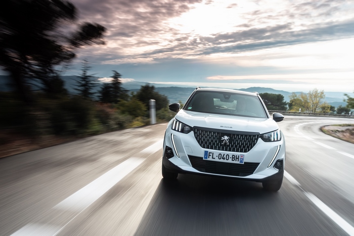 White Peugeot 2008 GT Line driving on a winding road
