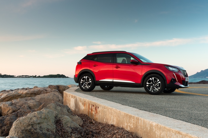 Red Peugeot 2008 SUV by the sea
