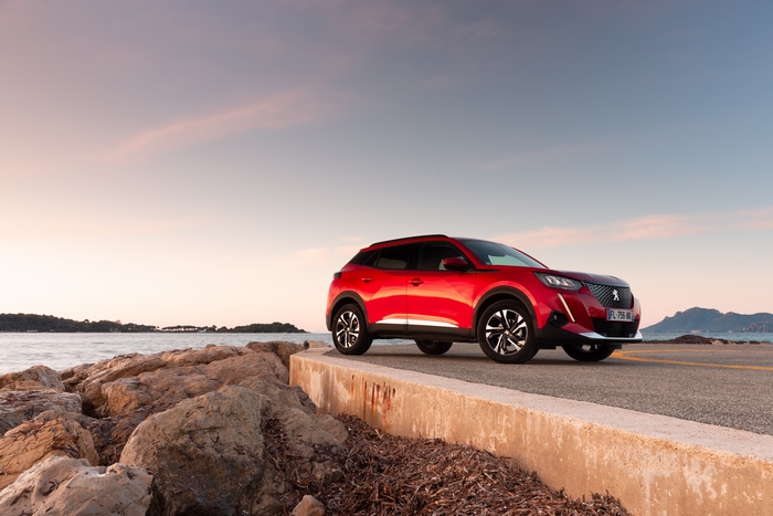 Red Peugeot 2008 SUV by the sea