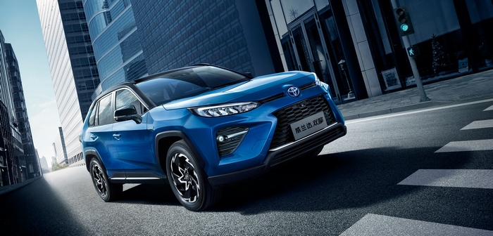 Blue Toyota Wildlander Hybrid SUV driving in city
