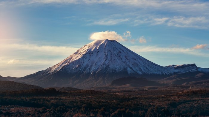 Snow-capped mountain with a cloud on top