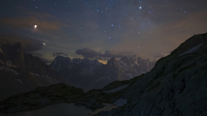 Mountain landscape under starry night sky
