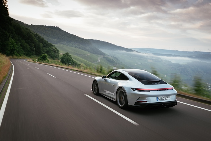 Silver Porsche 911 GT3 Touring on a winding road