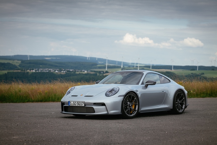 Silver Porsche 911 GT3 Touring with Wind Turbines
