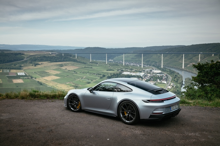 Silver Porsche 911 GT3 Touring on a scenic overlook