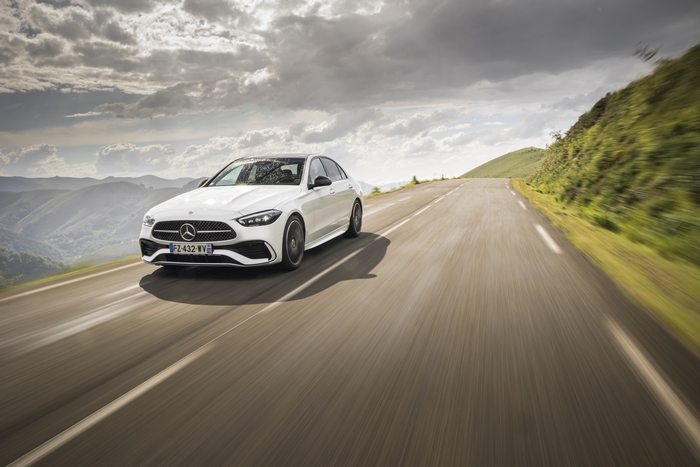 White Mercedes-Benz C 220 d AMG Line on a Mountain Road