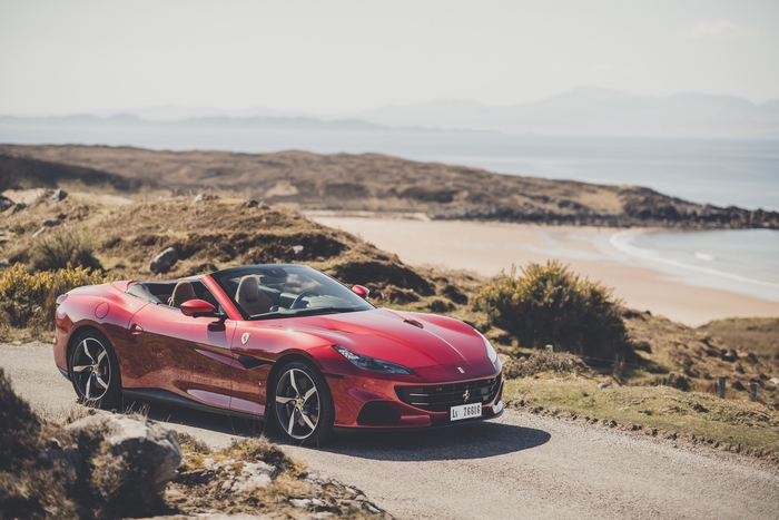 Red Ferrari Portofino M Convertible on Coastal Road