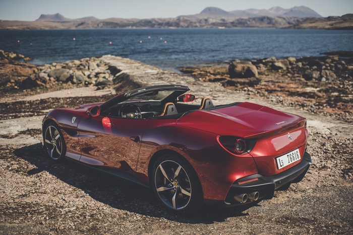 Red Ferrari Portofino M convertible by the sea