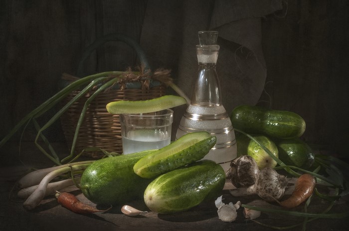 Still life with vegetables and a bottle of liquid