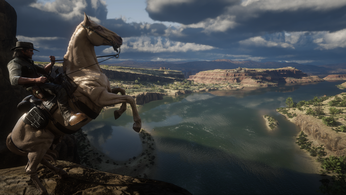 John Marston from Red Dead Redemption 2 on a horse overlooking a lake