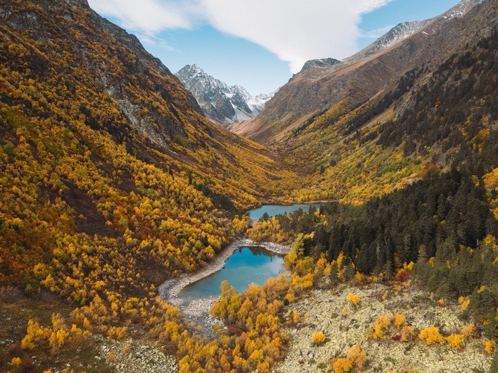Autumn mountain valley with lakes and snowy peaks
