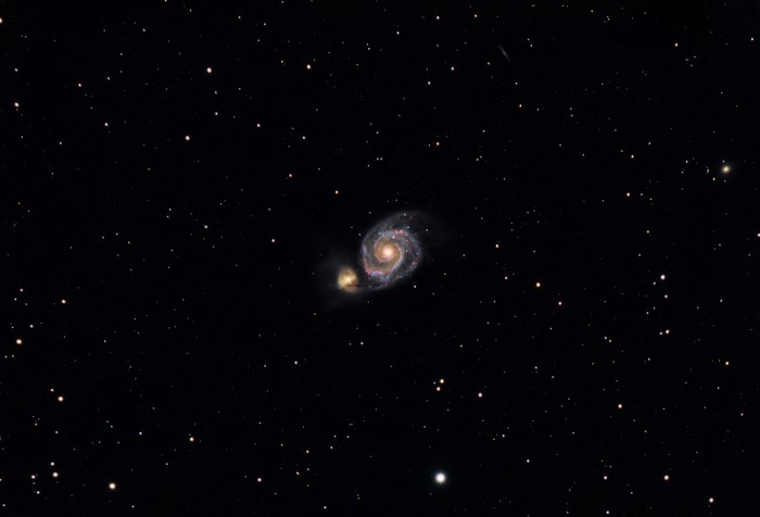 Whirlpool Galaxy and companion galaxy in space
