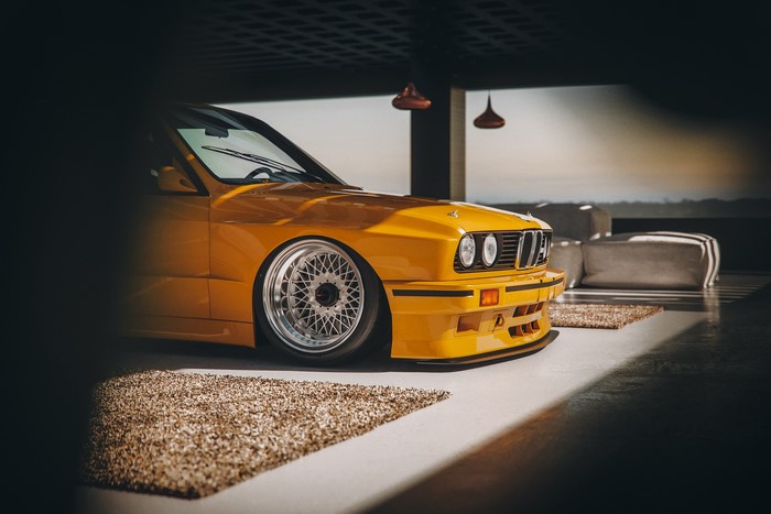 Yellow BMW M3 in a modern garage