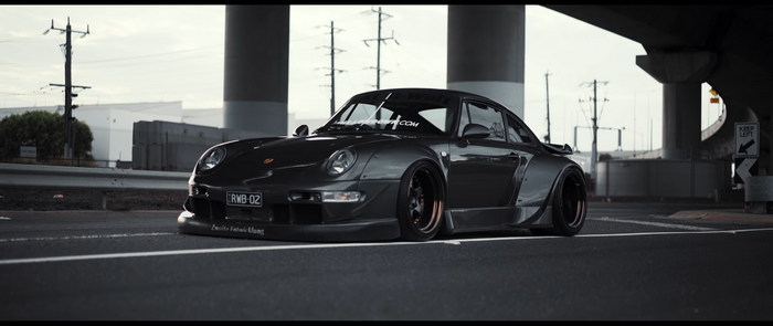 Dark grey Porsche 911 RWB 02 parked on asphalt