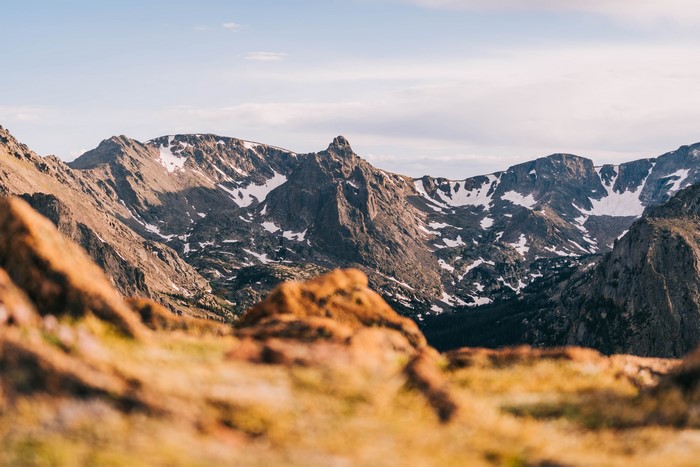 Snow-capped mountains under a cloudy sky