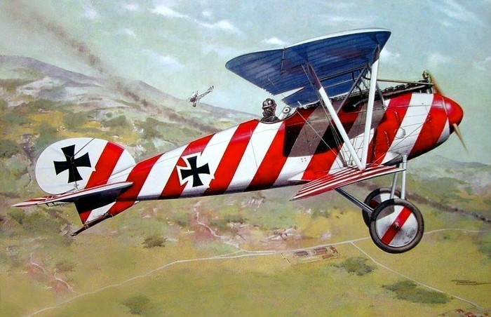 Red and white striped biplane in flight