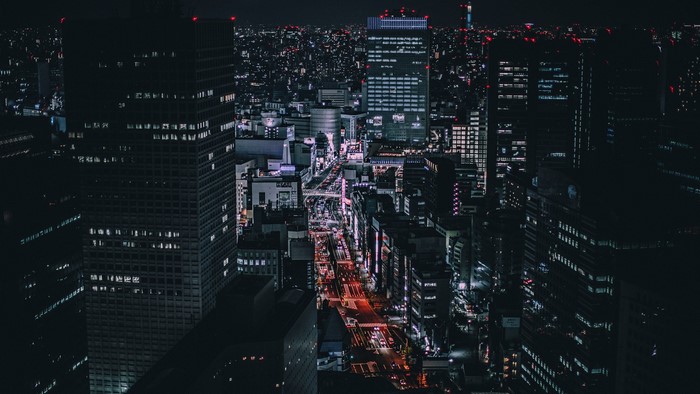 Nighttime cityscape of Tokyo with skyscrapers and streetlights