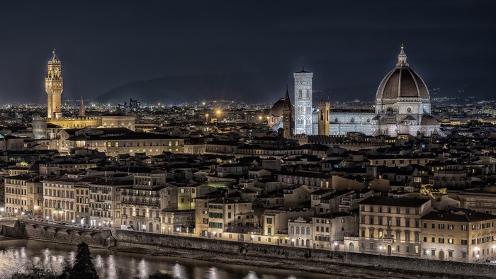 Florence cityscape at night with Arno River and Duomo