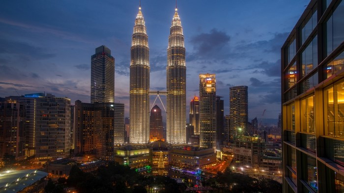 Petronas Towers cityscape at dusk in Kuala Lumpur