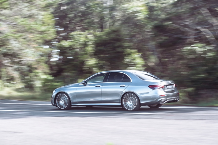 Silver Mercedes-Benz E 350 AMG Line driving on a road