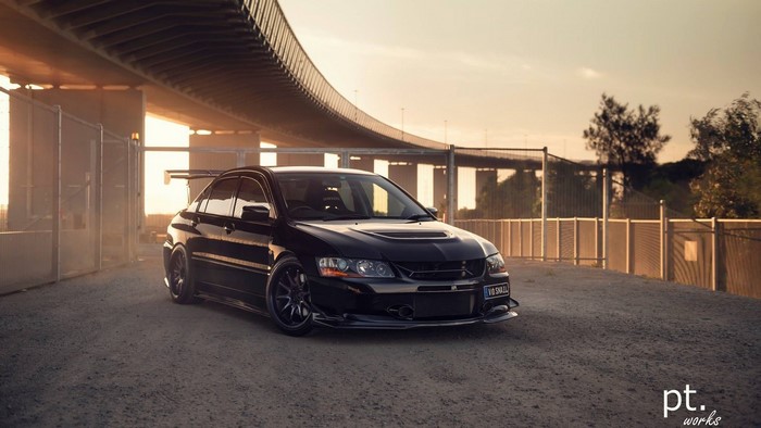 Black Mitsubishi Lancer Evolution JDM sports car at sunset