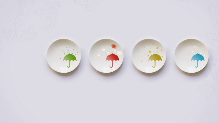 Four plates with seasonal umbrella designs