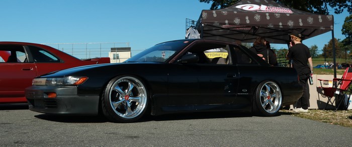 Black Nissan Silvia S13 drift car at event