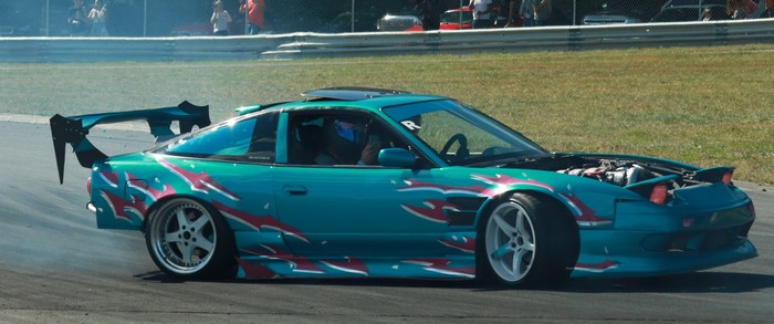 Teal drift car with custom graphics on track