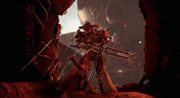 Warframe character with a large gun in a red environment