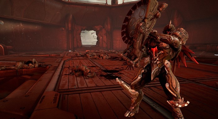 Warframe character with large shield in bloody arena