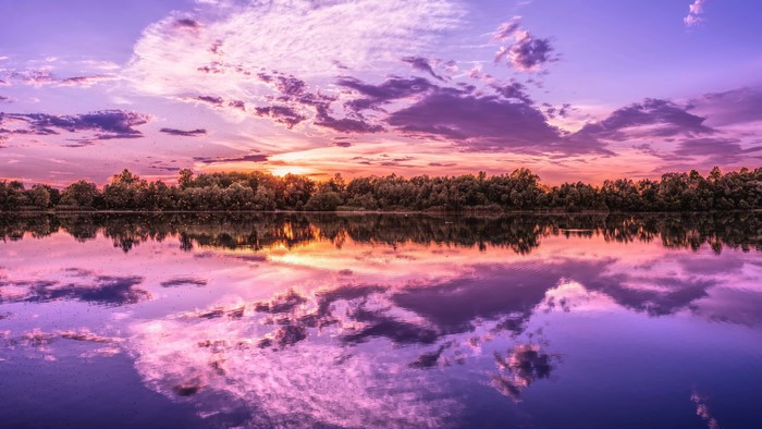 4K sunset over a lake with colorful clouds and reflection