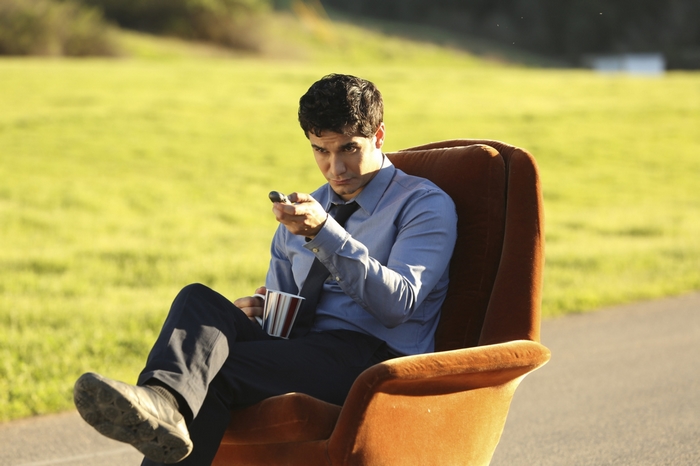 Walter O'Brien sitting in a chair with a remote