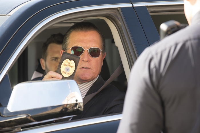 Robert Patrick as Cabe Gallo showing badge