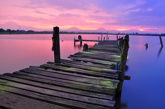 Wooden pier on a lake at sunset