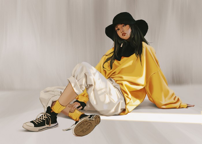 Woman wearing a yellow sweatshirt and black hat sitting
