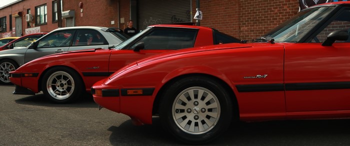 Red Mazda RX-7 cars at a car show