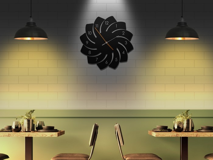Modern wall clock above tables in a restaurant