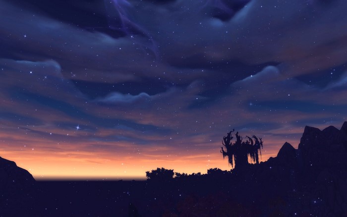Night sky with stars and sunset over mountains