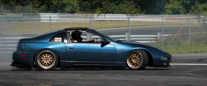 Blue Nissan 300ZX drifting on a race track