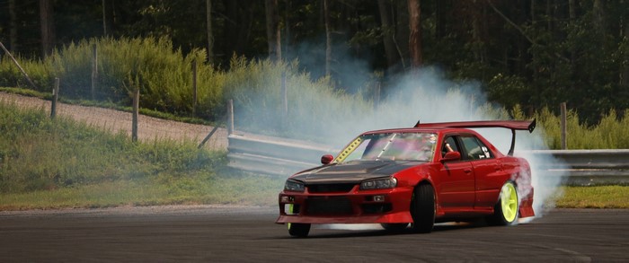 Red drift car with large spoiler on track
