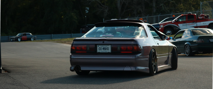 Mazda RX-7 on a race track with other cars