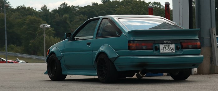 Teal Toyota AE86 drifting on a race track