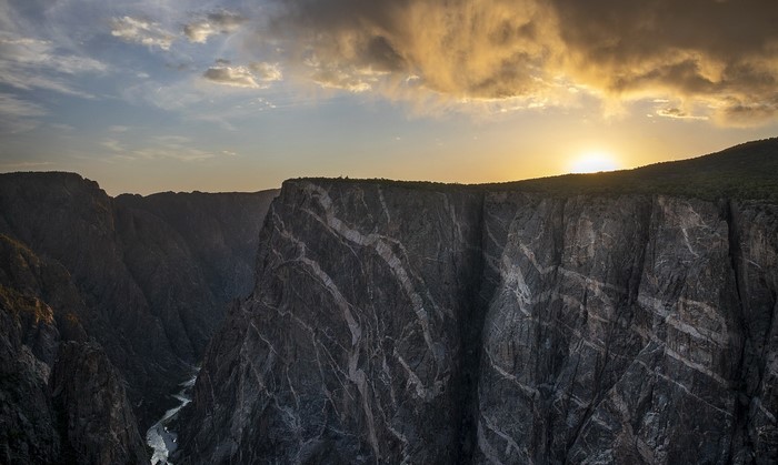 Sunset over a deep canyon with a river