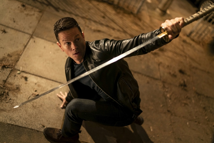 Mark Wahlberg as Evan McCauley with a sword