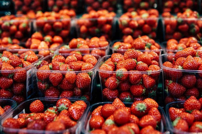 Plastic containers filled with fresh strawberries